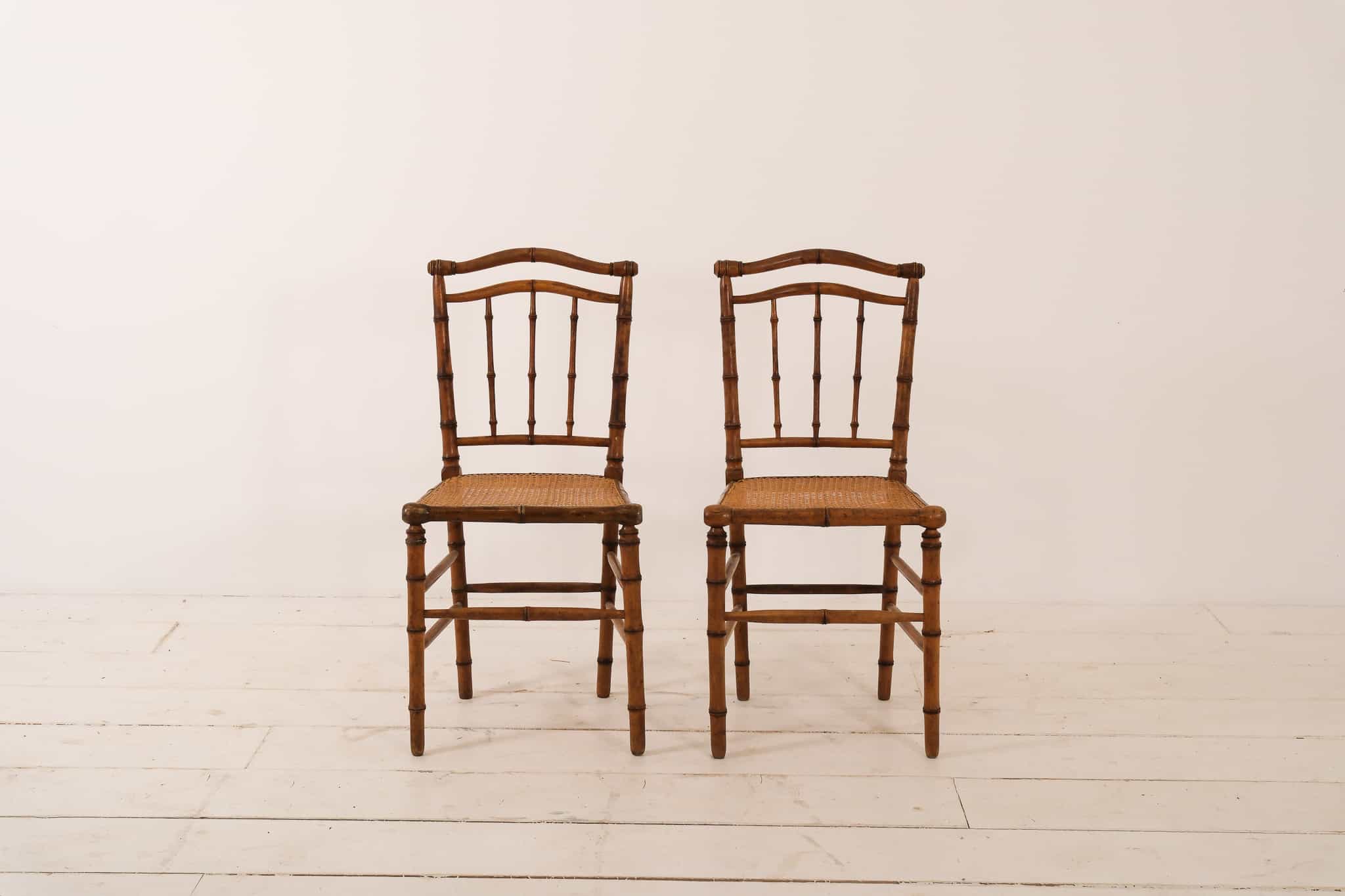 A pair of bamboo and cane chairs